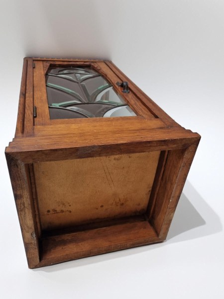 Bottom view of compact oak display cabinet with glass side panels